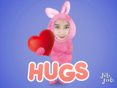 a girl in a pink bunny costume is holding a red heart with the words hugs behind her
