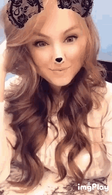 a woman wearing a lace headband with ears and a nose