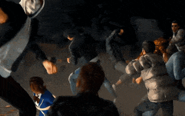 a group of people are dancing in a dark room and one of them is wearing a yellow hoodie