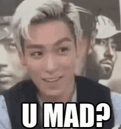 a young man is making a funny face and says `` u mad ? ''