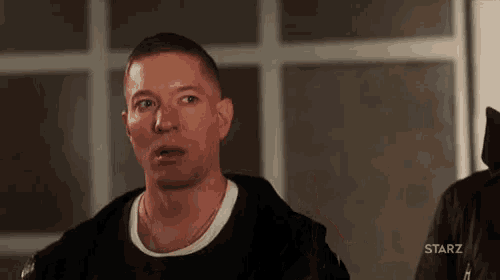 a man is making a funny face in a room .