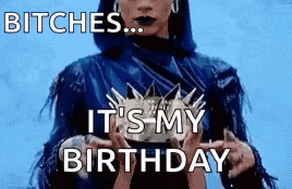 a woman in a blue jacket is holding a crown in her hands .