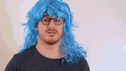 a man with a beard wearing a blue wig and glasses