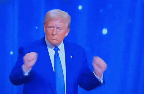 donald trump is wearing a blue suit and tie and dancing