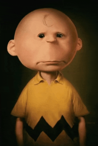 a cartoon character with a c on his forehead is wearing a yellow shirt
