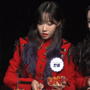 a woman in a red jacket has a badge that says dreamcatcher