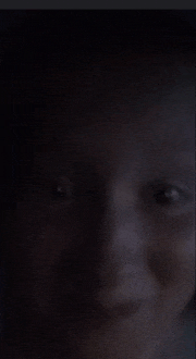 a blurry picture of a person 's face with a dark background