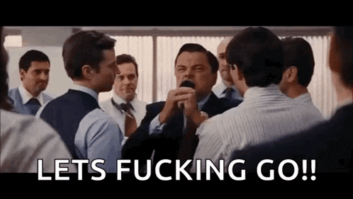 a group of men are standing around a man holding a microphone and saying let 's fucking go !