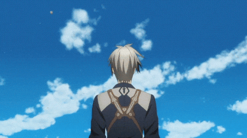 a man in a suit stands in front of a blue sky with clouds