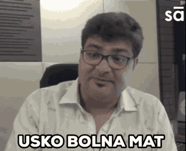 a man wearing glasses and a white shirt says " usko bolna mat "