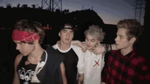 a group of young men are posing for a photo with one wearing a bandana that says 666