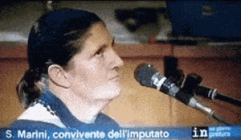 a woman is speaking into a microphone with the words s. marini convincente dell ' imputato written below her