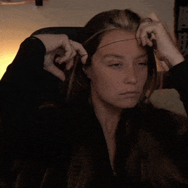 a woman yawning with her eyes closed and her mouth wide open