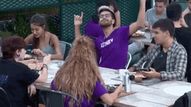 a man in a purple shirt with the word journey on it