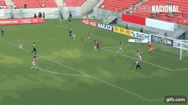 a soccer game is being played in a stadium sponsored by sachs