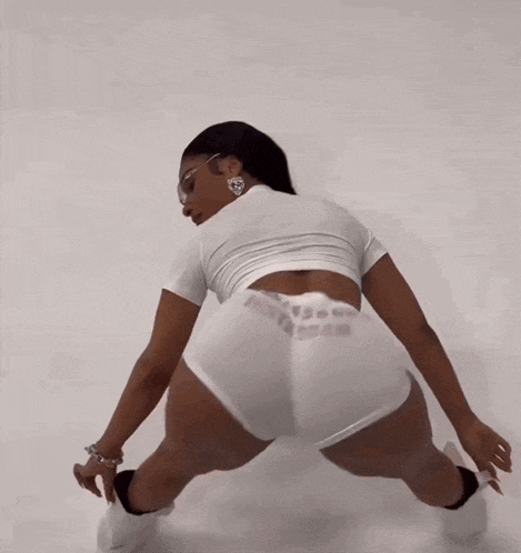 a woman wearing a white top and shorts with the word besta on it