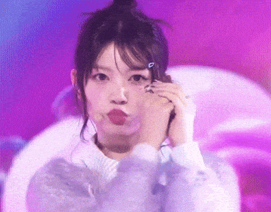 a girl making a funny face with a pink background