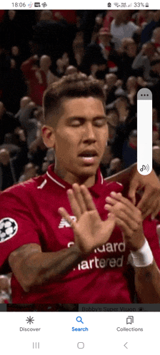 a soccer player wearing a red shirt that says standard artered