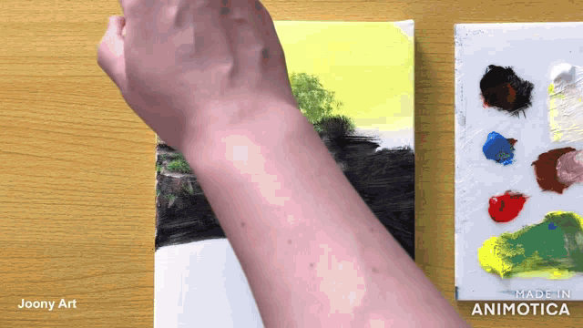 a person is painting a picture with a palette behind them that says ' made in animatica '