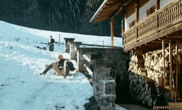 a person is sliding down a snowy hill and the website joyreactor.com is visible