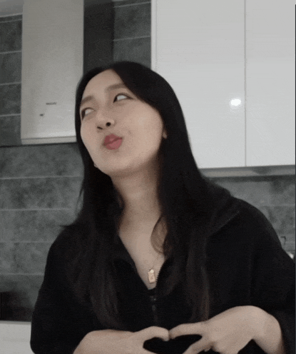 a woman making a funny face with her hands