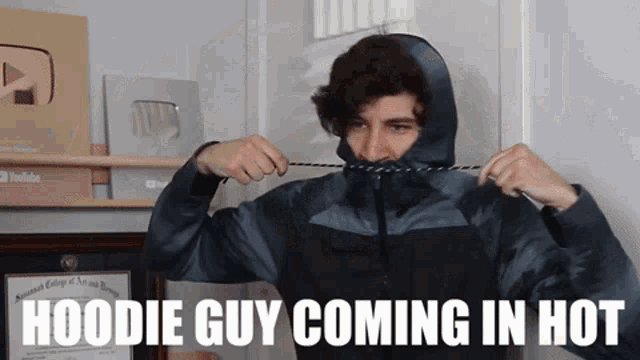 a man wearing a hoodie with the words " hoodie guy coming in hot " above him
