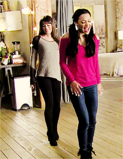 two women are standing next to each other and one is wearing a pink top