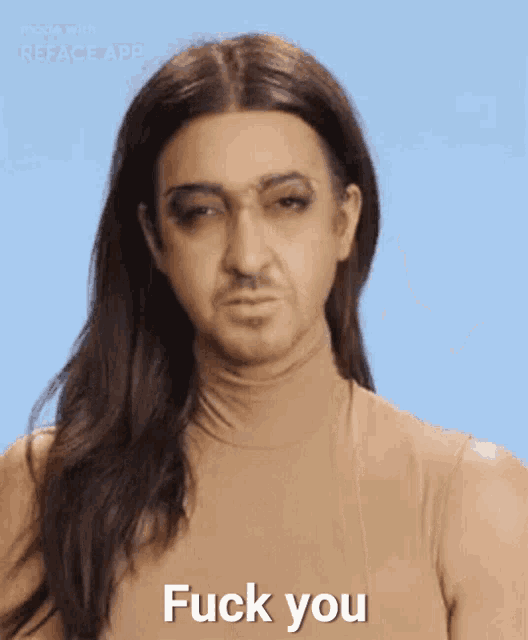 a man with long hair says " fuck you "