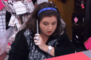 a woman wearing a watch and a headband is talking on a phone