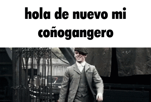 a man in a suit and hat is walking in front of a sign that says hola de nuevo mi conogangero .