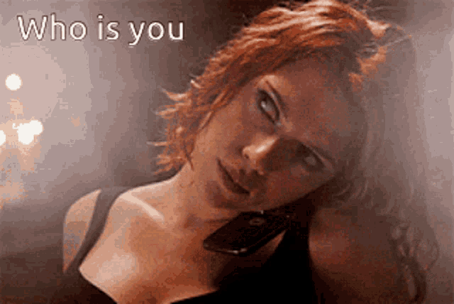 a woman talking on a cell phone with the words who is you written above her