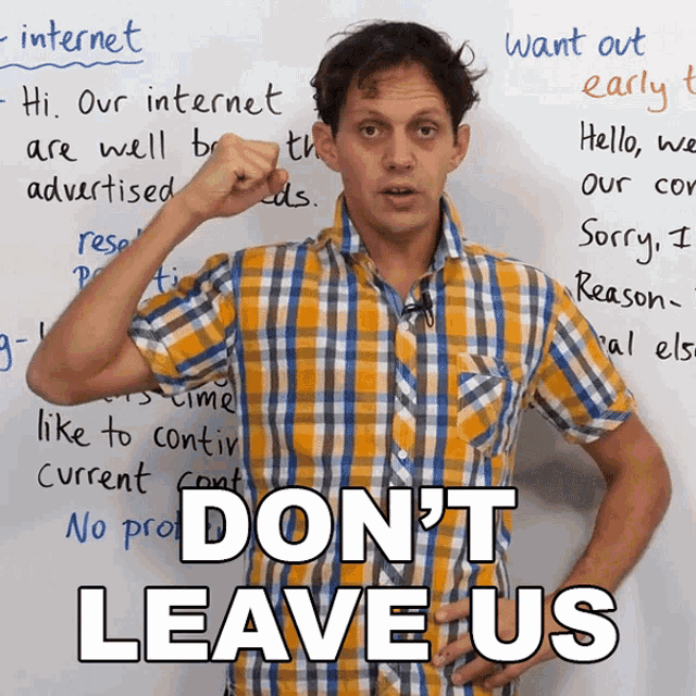 a man in a plaid shirt stands in front of a white board with the words " do n't leave us "