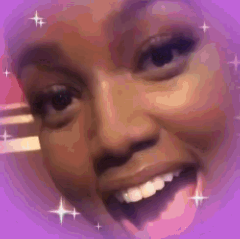 a close up of a woman 's face with a pink background and stars around it .