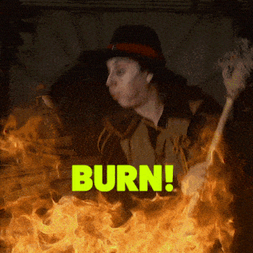 a person holding a stick in front of a fire with the word burn written in green