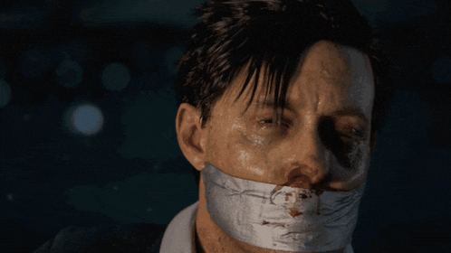 a man with duct tape on his mouth has a drawing of a face on it