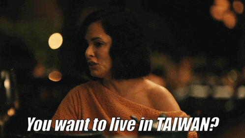 a woman sitting at a table with the words " you want to live in taiwan "