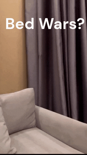 a couch in a living room with the words bed wars written above it
