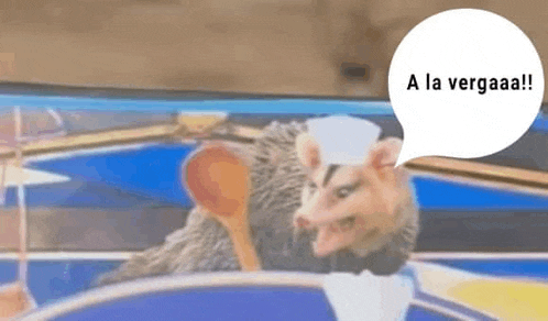 a opossum is holding a spoon in its mouth and a speech bubble with the word a la .
