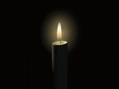 a candle with a picture of a man on it is lit up