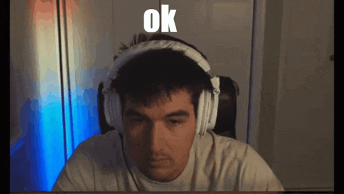 a man wearing headphones has the word ok on his face
