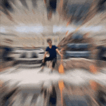 a blurry picture of a man in a blue shirt running