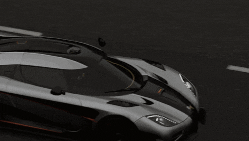 a gray and black sports car with the word one on the side