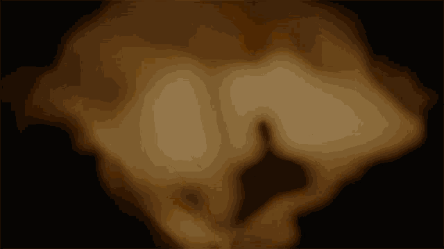 a blurred image of a person holding a candle in their hand