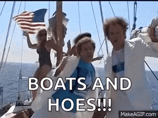 a group of people are standing on a boat in the ocean and a woman is holding an american flag .