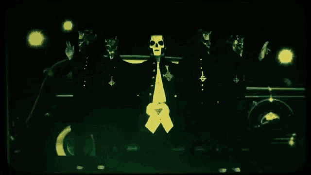 a man with a skull on his face is standing next to two other men
