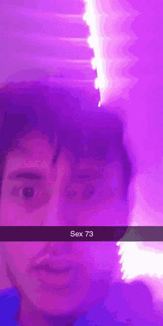 a man 's face is visible in front of a purple background with the words sex 73 on it