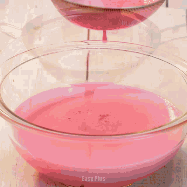 a person is cracking an egg into a glass bowl with the word egg below them