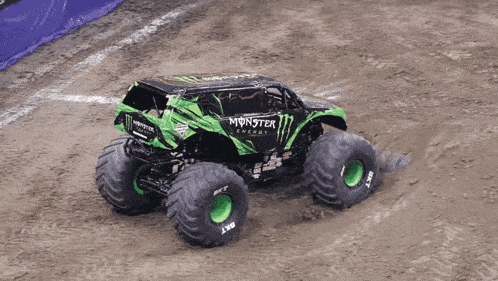 a monster truck is driving through the mud