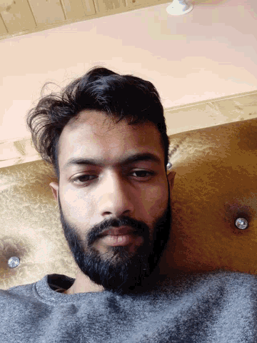 a man with a beard is laying on his back