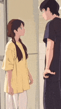 a man and a woman are standing next to each other and looking at each other